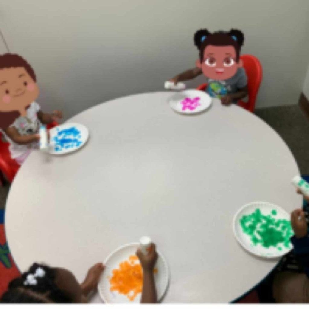 Preschool Children doing art painting paper plates with dot markers